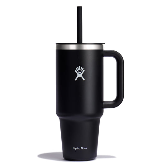 Black tumbler with handle, straw, and a white logo of a figure in a circle.