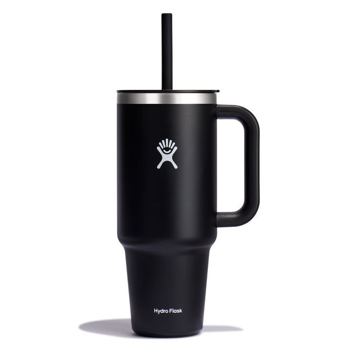 Black tumbler with handle, straw, and a white logo of a figure in a circle.