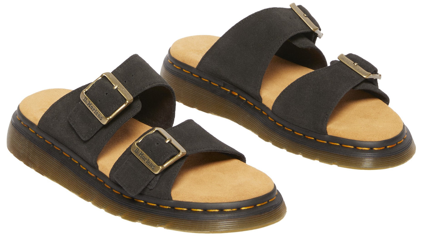 Pair of black, two-strap sandals with gold buckles and yellow stitching.
