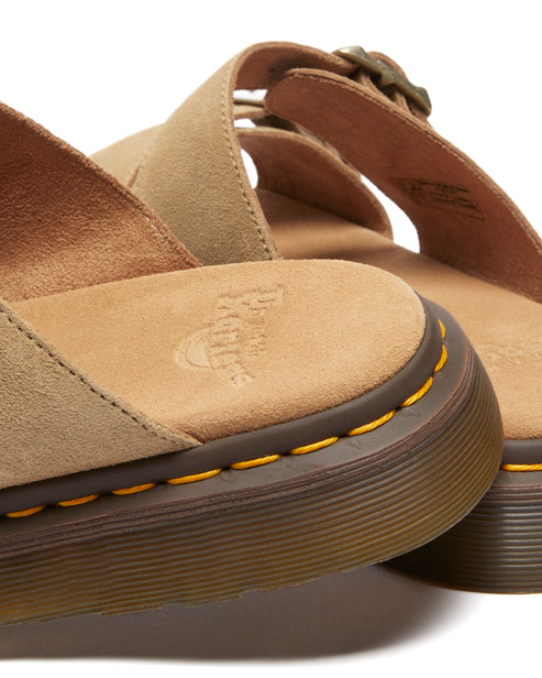 Sandals with tan straps and yellow stitching.
