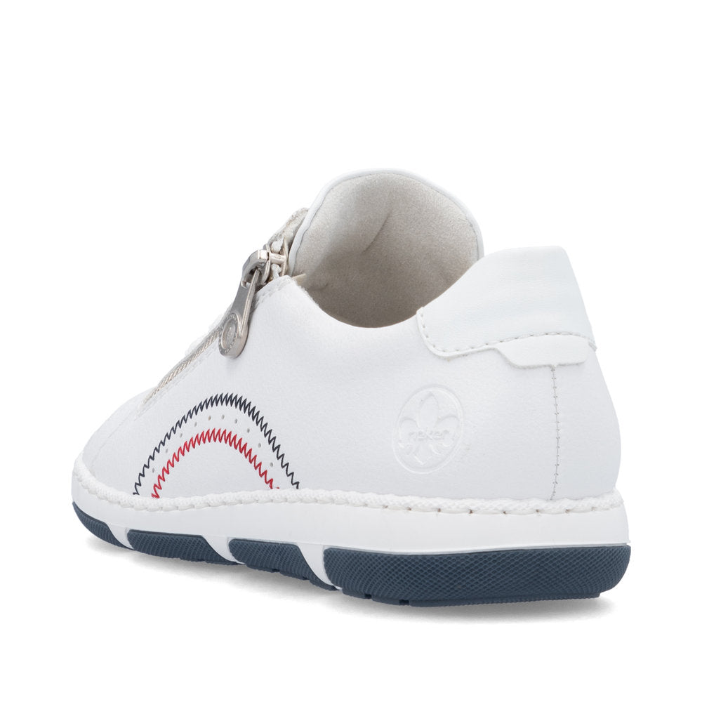 White sneaker with zipper detail, decorative blue and red waves, and navy blue sole.