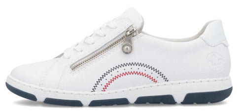 White sneaker with zipper detail and blue and red decorative stitching.