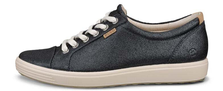 A dark-colored sneaker with white laces and a light beige sole.