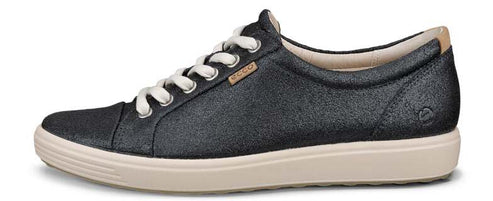 A dark-colored sneaker with white laces and a light beige sole.