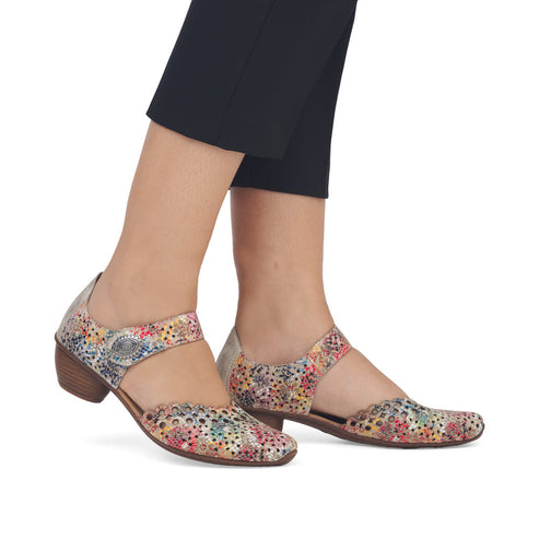 Floral patterned leather Mary Jane shoe with a block heel being worn.