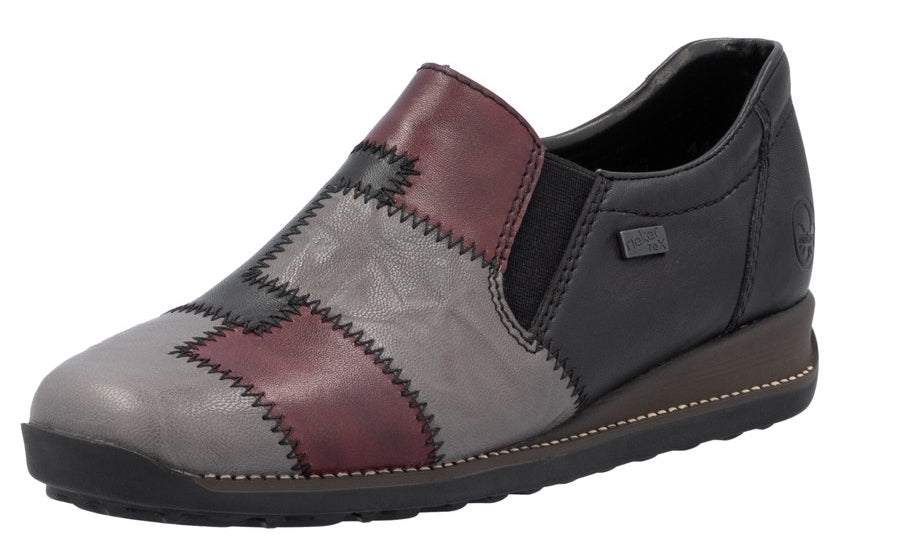 Slip-on shoe with patchwork pattern and low wedge heel.