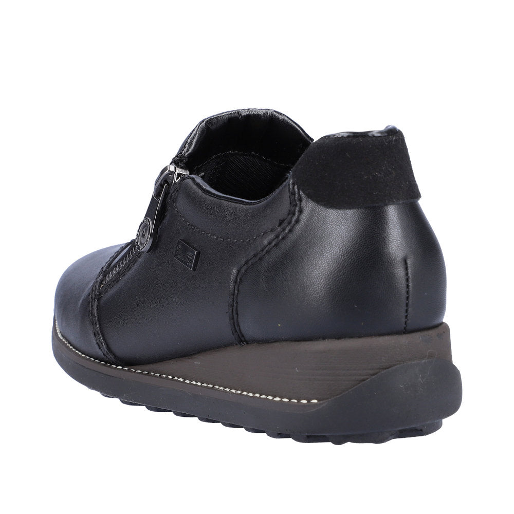 Low black leather shoe with zipper and a low wedge sole.