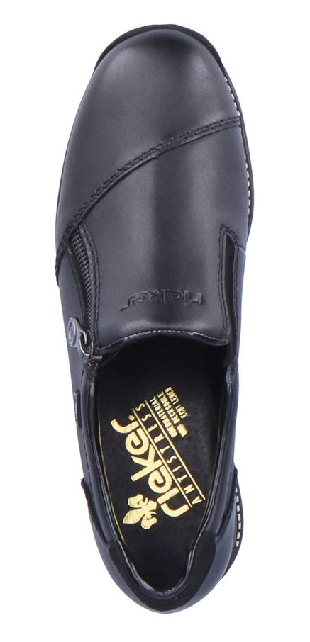 A black slip-on shoe with decorative stitching and a small zipper.