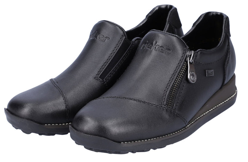 Two black leather loafers, one with a zipper detail and "Rieker" on the side