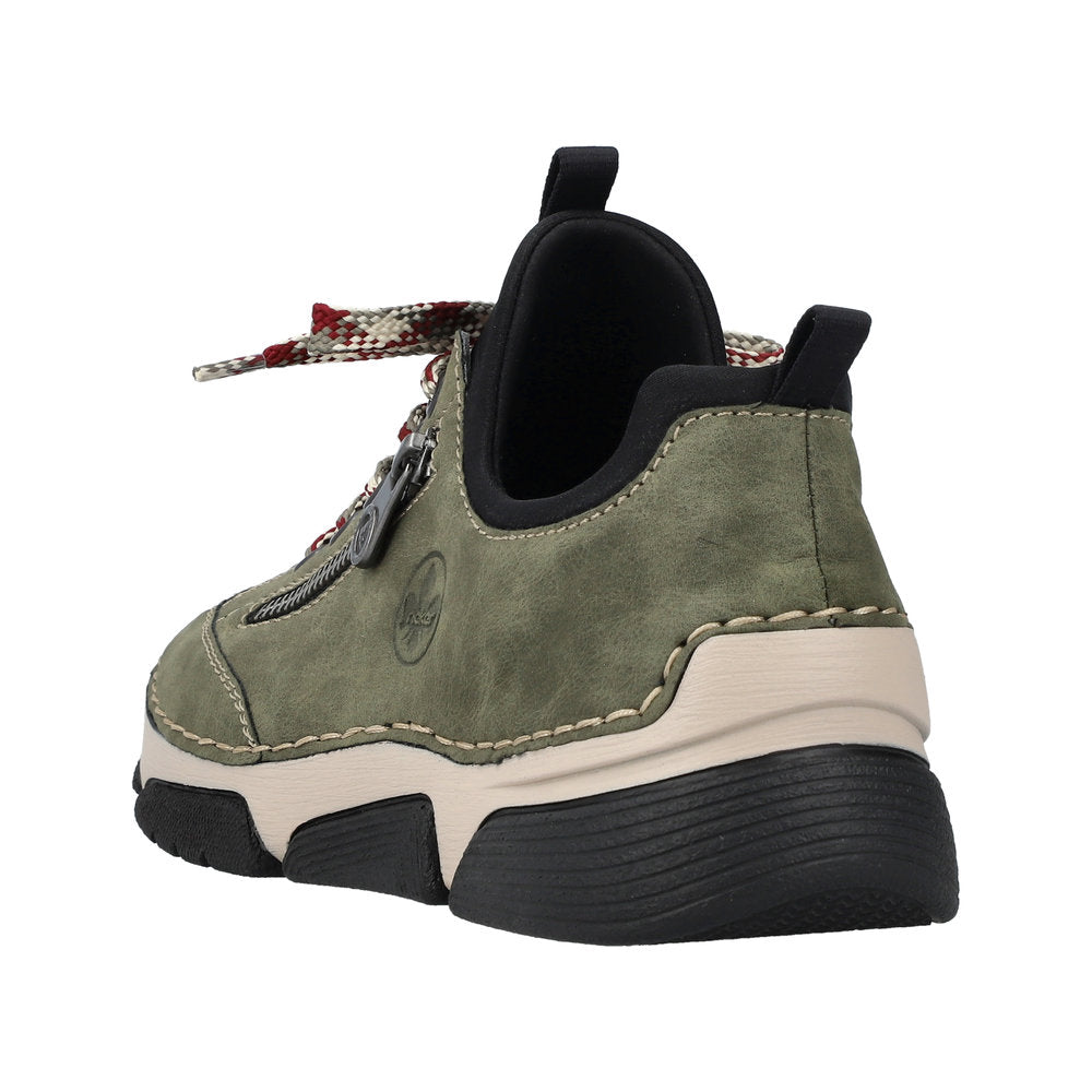 Green sneaker with black sole and red/white laces