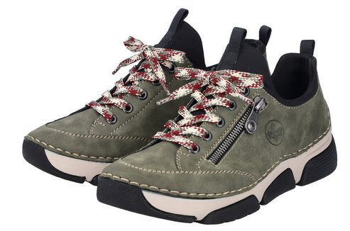 A pair of low-profile olive-green shoes with white midsoles and black outsoles. The shoes have red and white patterned laces and a zipper detail on the side.