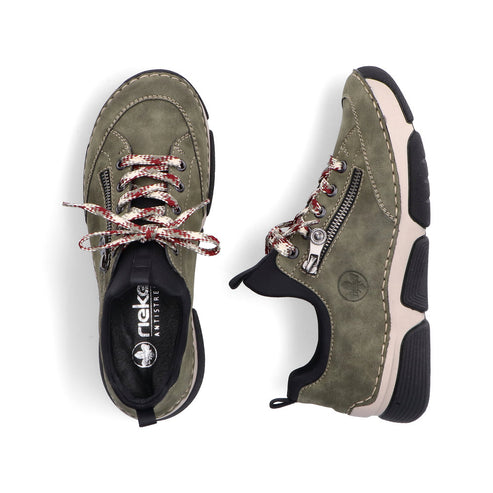Pair of olive-green shoes with a zipper, decorative laces and black and beige sole.