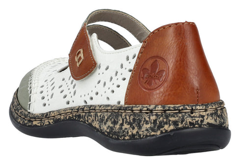 White and brown leather mary jane shoe with decorative perforations and a hook-and-loop strap.