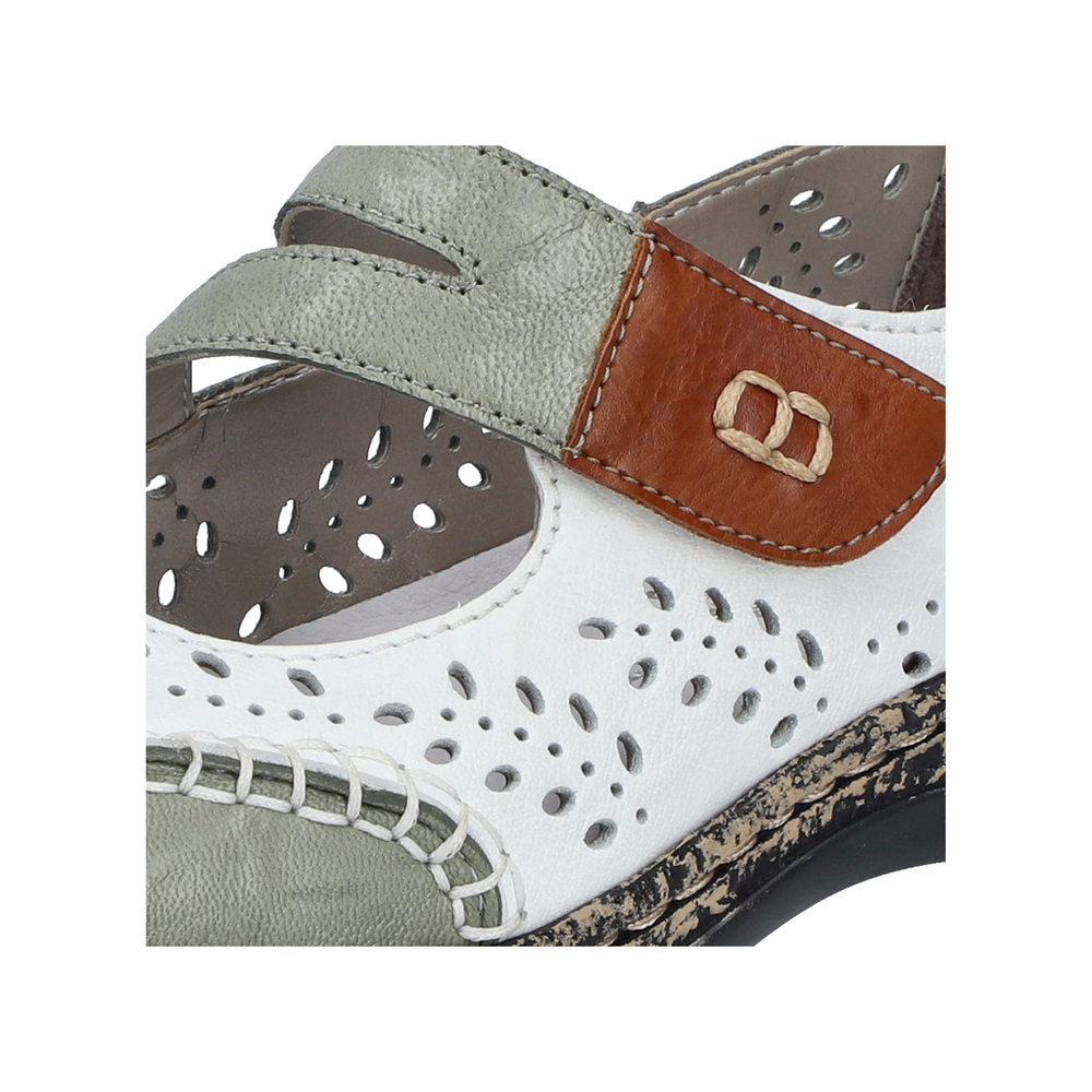 Close-up of a white and gray sandal with cut-out details and adjustable straps.