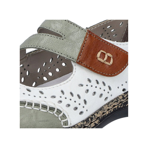 Close-up of a white and gray sandal with cut-out details and adjustable straps.