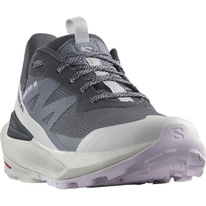 A gray and white low top trail running shoe with a lug sole and visible laces.