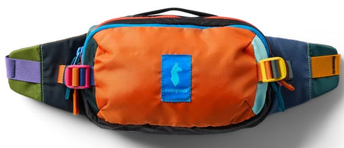 A colorful fanny pack with an orange front pocket, a blue logo patch featuring a llama silhouette, black top and bottom, and various accent colors including purple, olive green, bright blue, yellow, and dark blue on the straps and trim.