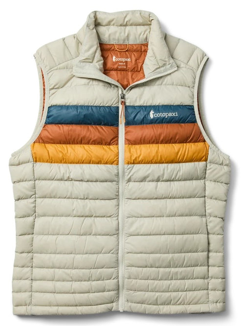 A light cream-colored puffer vest with a high collar and a full-length front zipper. Across the chest are three horizontal stripes in blue, rust orange, and gold. The interior of the vest is also rust orange, and the word 'cotopaxi' is printed on the blue chest stripe.
