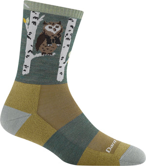 A sock that has an owl sitting on birch tree branches and the sock itself is sectioned off into different color patterns.