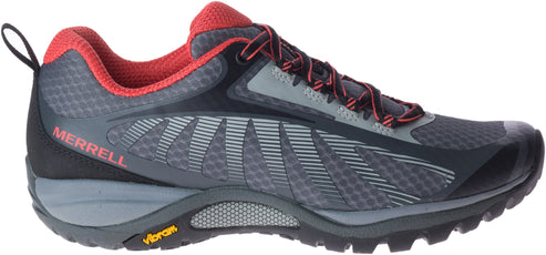 A sneaker with gray mesh, red accents, and a Vibram sole.