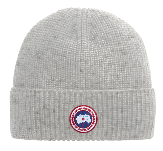 Close-up of a light-gray knit beanie with a red and blue round logo patch at the front.