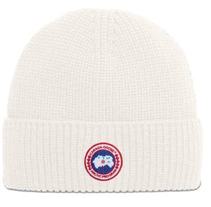 White knit beanie with Arctic Program badge.