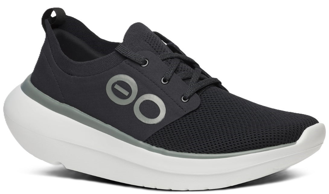 A black athletic shoe with a thick white sole, gray accents, and black laces.