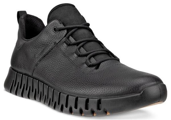 A low-top black leather sneaker with black laces and a thick, ridged sole.