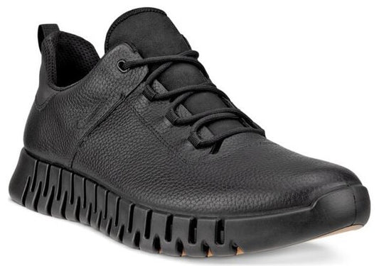 A low-top black leather sneaker with black laces and a thick, ridged sole.