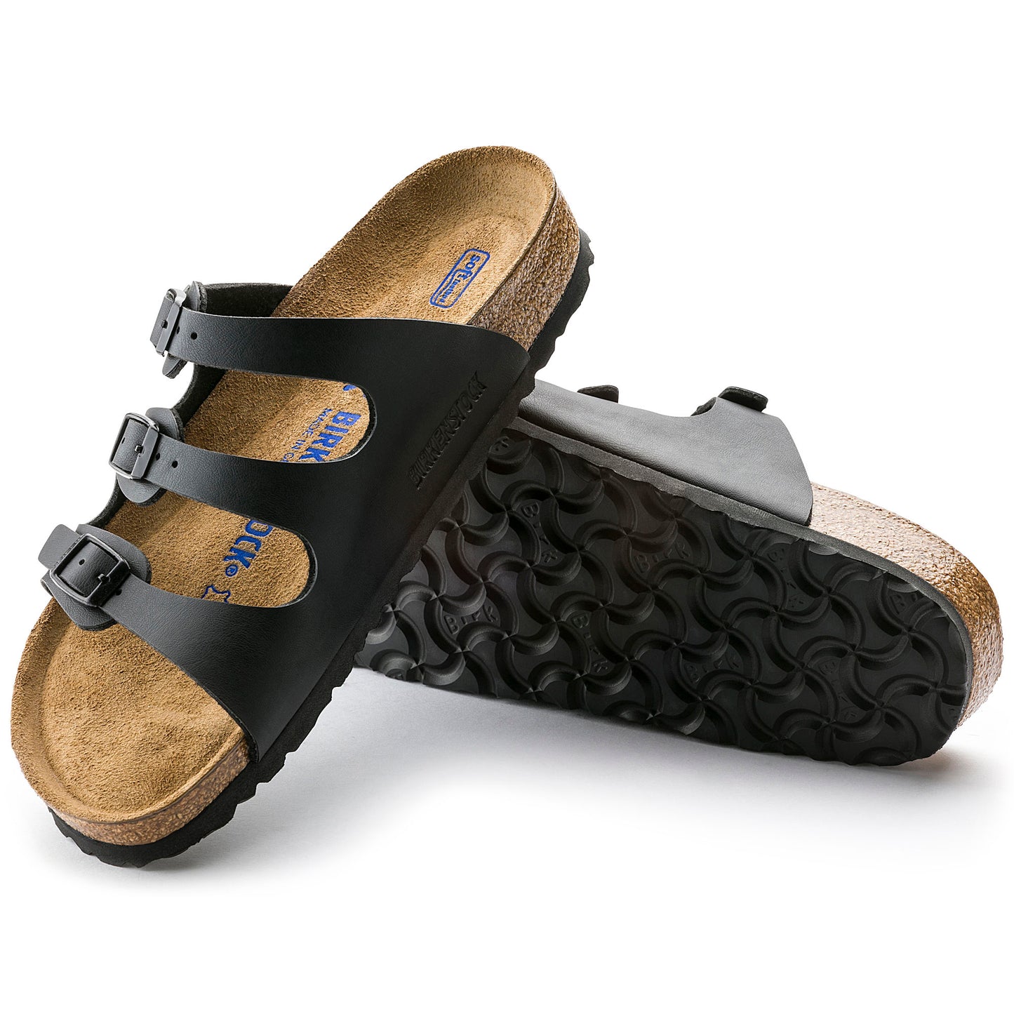 Black sandal with three straps and adjustable buckles, cork sole with black tread.
