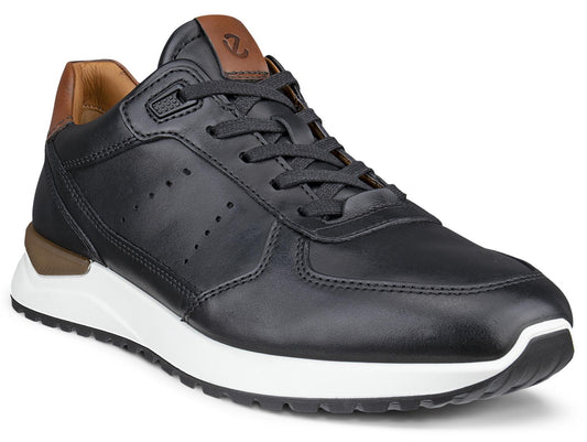 A black leather sneaker with brown accents on the heel and tongue, featuring a thick white midsole and a black treaded outsole.