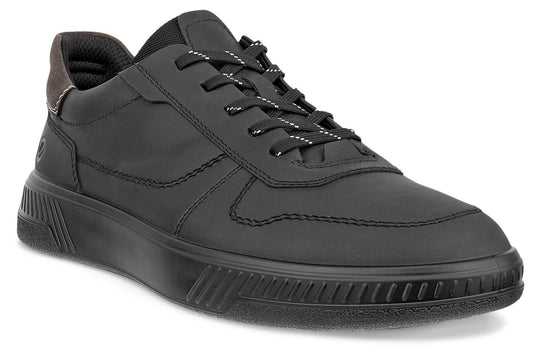 A black casual sneaker with a matte finish, featuring matching black laces with thin white reflective accents, a smooth rounded toe box, detailed tonal stitching along the side panels, and a textured ribbed pattern on the thick rubber midsole.