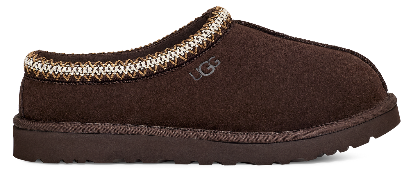 Brown slip-on shoe with decorative trim and a visible "UGG" logo.