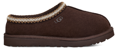 Brown slip-on shoe with decorative trim and a visible "UGG" logo.