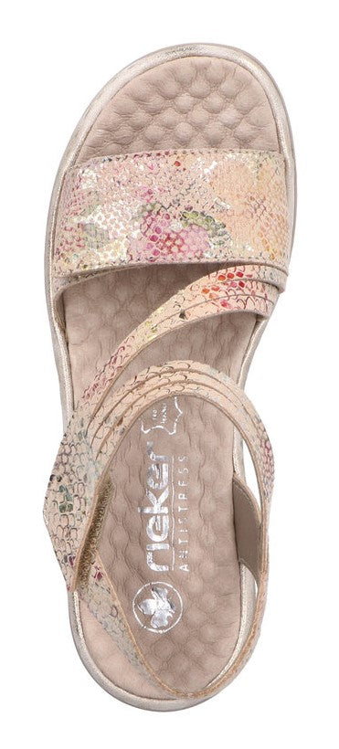 Beige sandal with floral pattern and criss-cross straps.