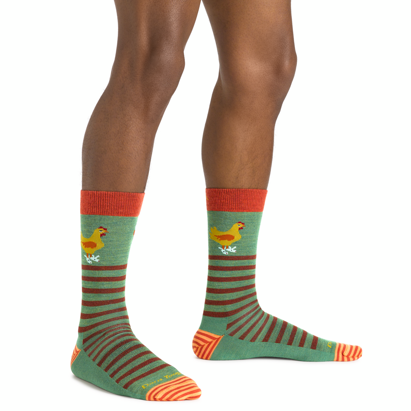 Pair of calf-length socks, green with brown stripes and orange toe, heel, and top, each featuring a cartoon chicken.