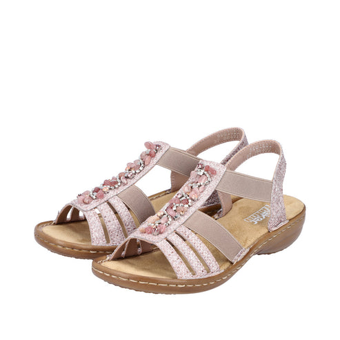 Pair of women's flat sandals with pink embellishments and elastic straps.