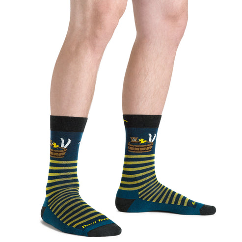 Person wearing socks with a yellow striped barrel, white cat, and yellow duck design on navy blue, along with the text "Don't Touch" at the toe.
