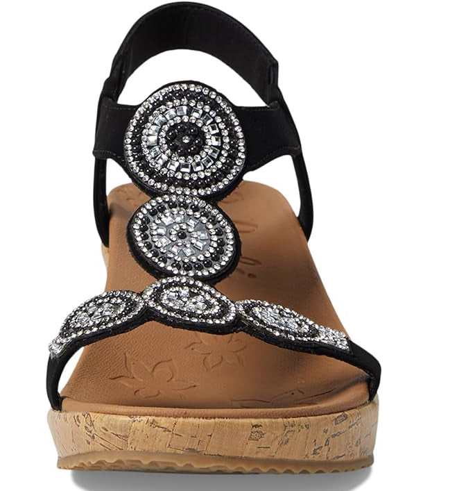 Black wedge sandal with circular silver beaded embellishments.