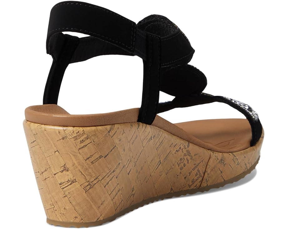 Black wedge sandal with cork sole and elastic straps.