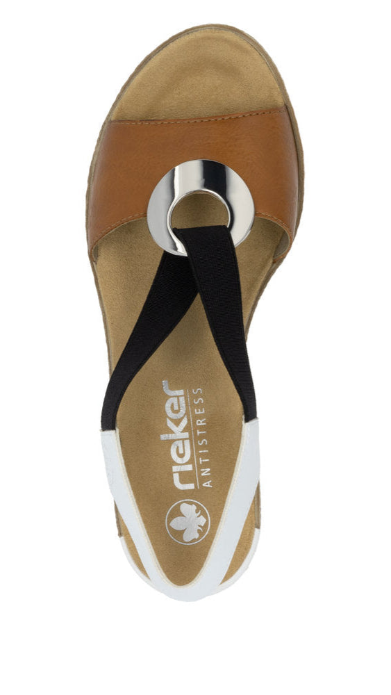 Sandal with a brown toe opening and a silver ring detail on the brown strap, connected to a black and white heel strap, exposing the insole.