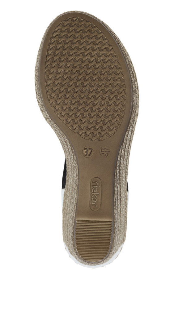 Close-up of the sole of a wedge heel sandal with a brown rubber tread, a label displaying 'Rieker' and a size marking of '37'.
