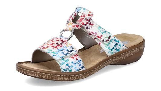 Slide sandal, white with colorful geometric pattern, three straps joined by silver rings, contoured footbed, low wedge.