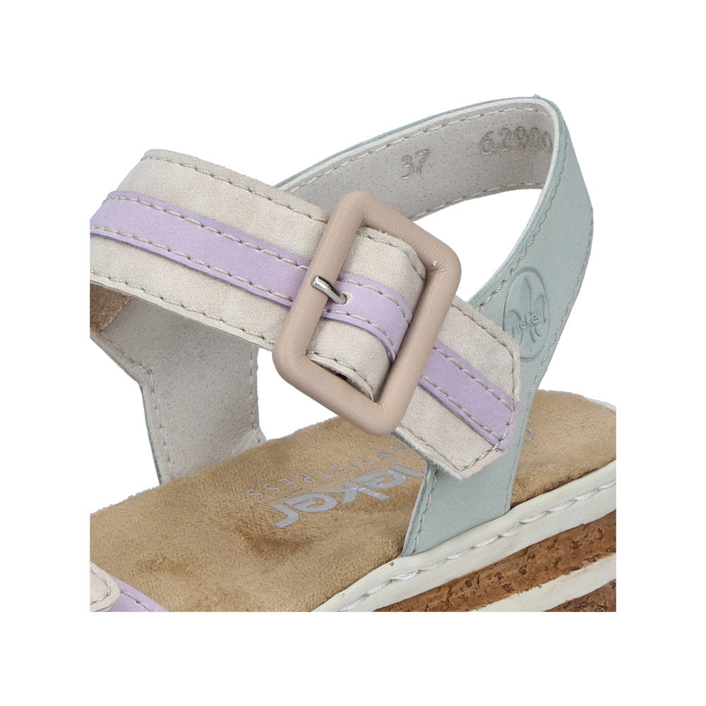 Close-up of a sandal with a square buckle, featuring off-white, lilac, and light blue colors.