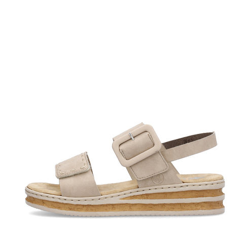 Beige sandal with buckle and platform sole.