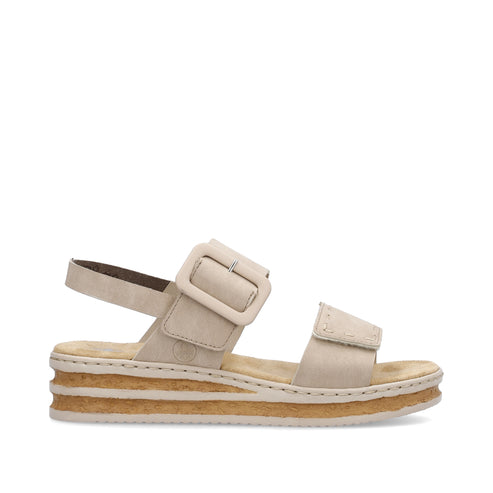 Beige sandal with buckle and platform sole.