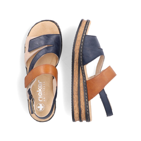 Two rieker sandals; one right side up, other on its side. Sandals have navy, tan and brown straps, adjustable ankle strap and cork sole.