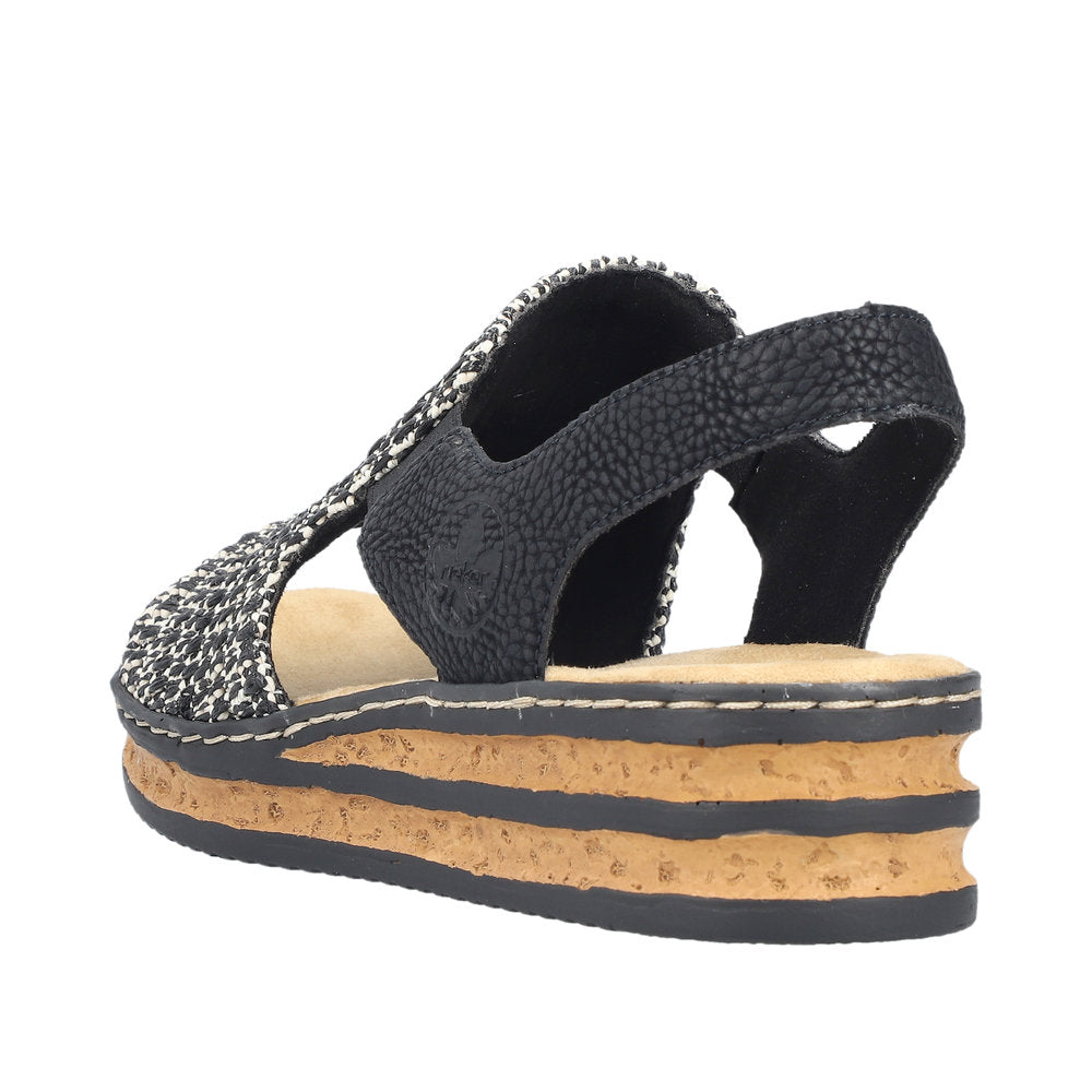 Low profile platform sandal with black and white woven upper and black slingback strap.