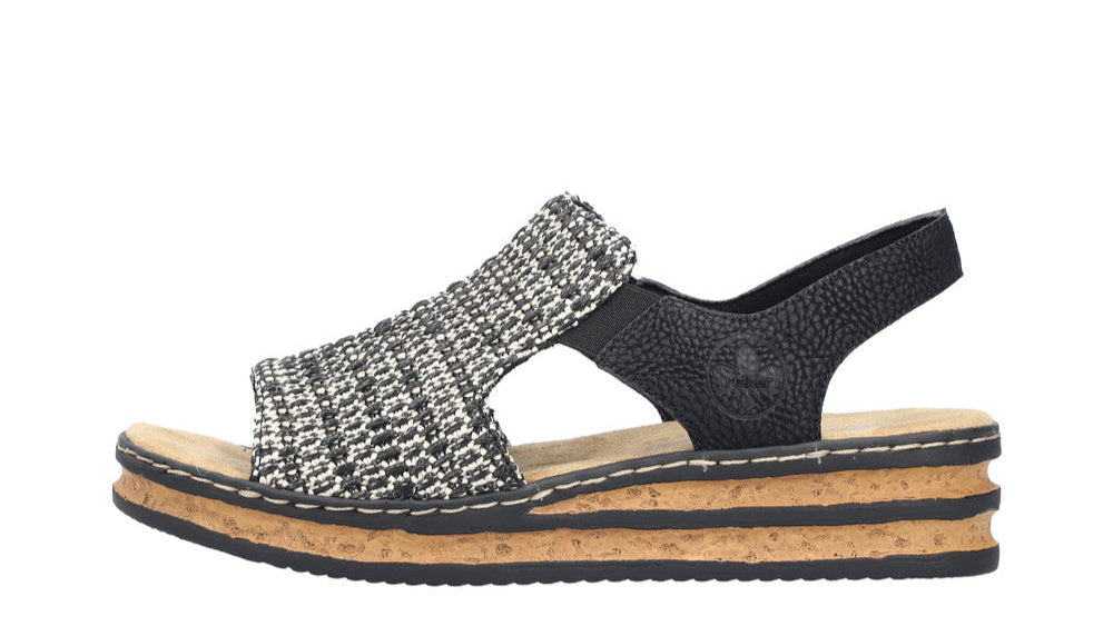 Women's platform sandal with woven-style black and white strap and black ankle strap.