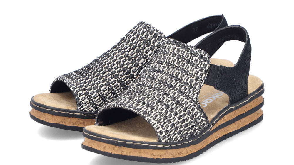 A pair of open-toe platform sandals with a black and white woven top, black heel strap and a light brown insole.